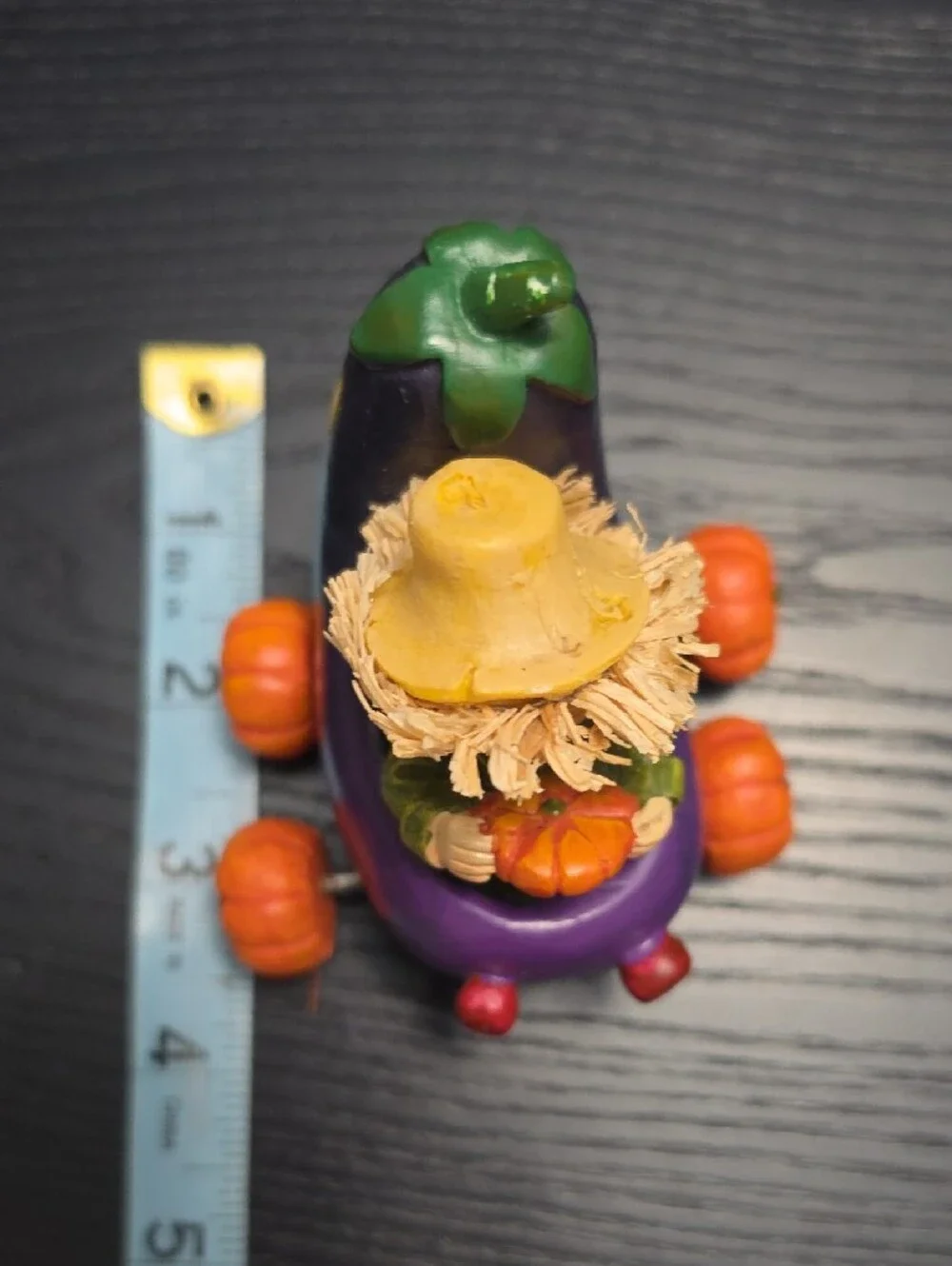 Autumn figurine of a scarecrow in a Eggplant cart